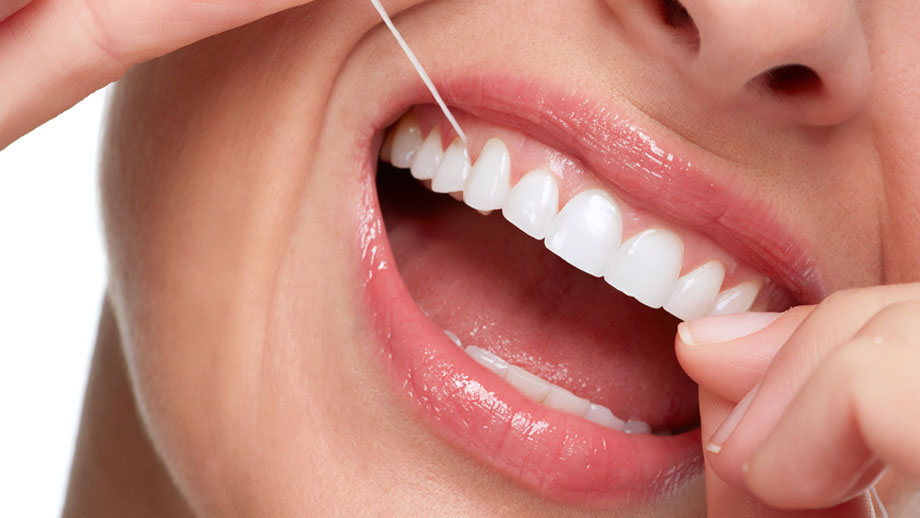 A nurse observing a client's mouth for white plaque-like lesions, with multiple choice options listed on the side