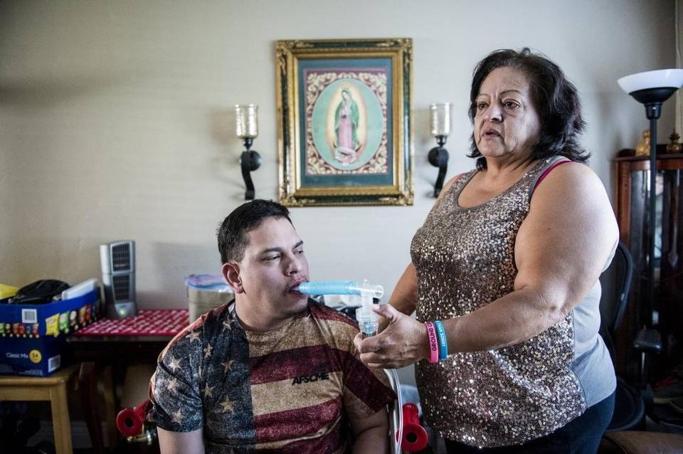 Merced resident Susana Saldana, 56, speaks about taking care of her son Mario Resendez, 29, while giving him his daily medicine used in a nebulizer at their home in Merced, Calif., on Wednesday, Sept. 14, 2016.