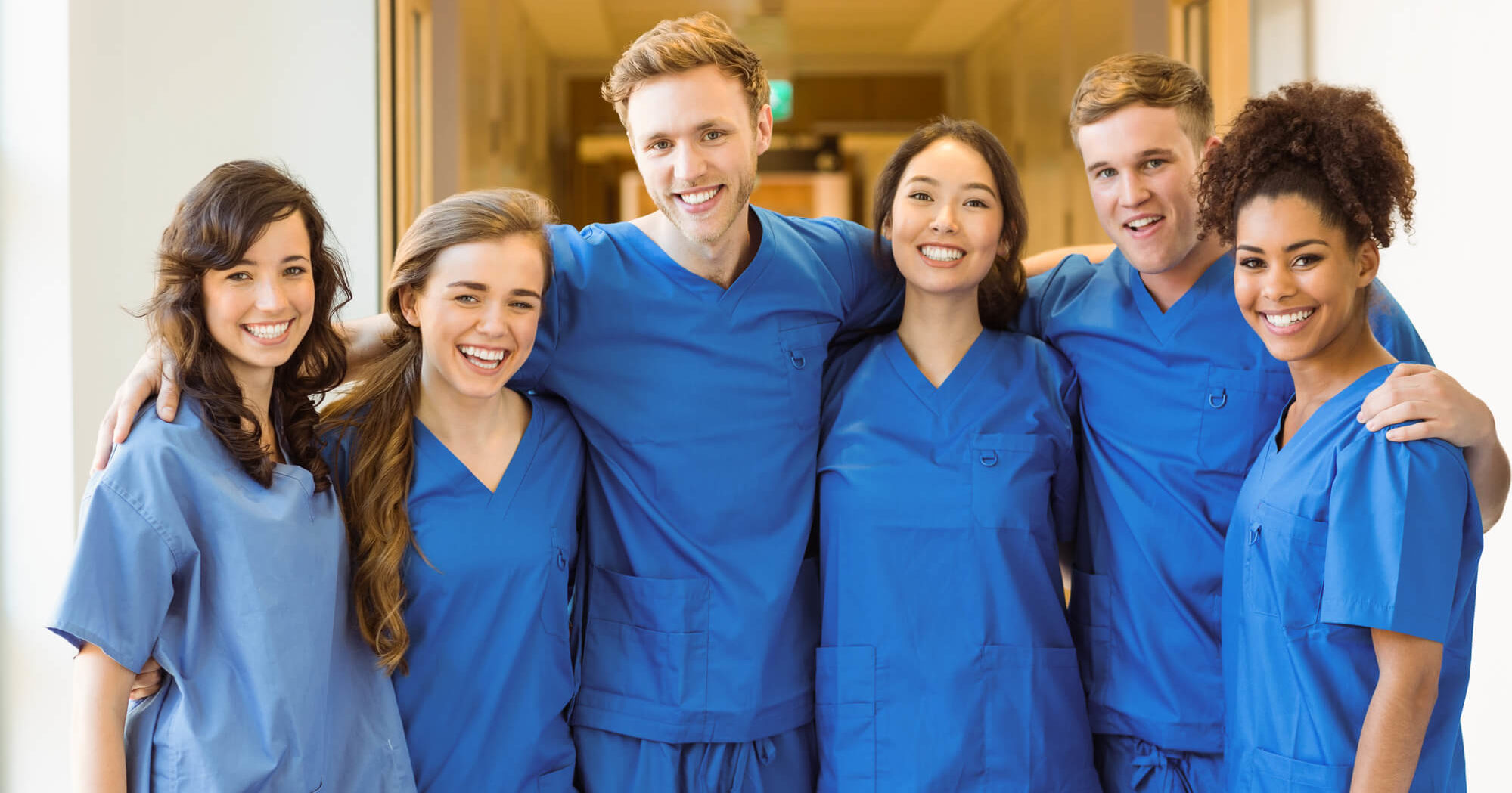 Image of a Certified Registered Central Service Technician (CRCST) holding their certification diploma in a sterile processing department of a healthcare facility